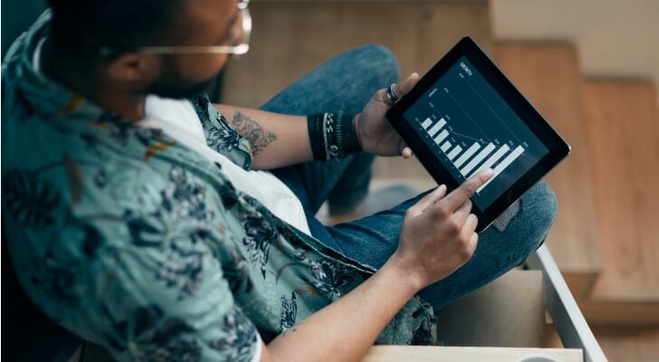 Black man using his mobile trading app