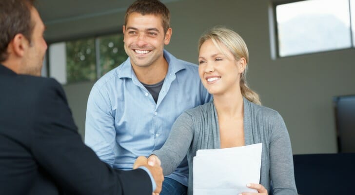 A happy couple working with their financial advisor.