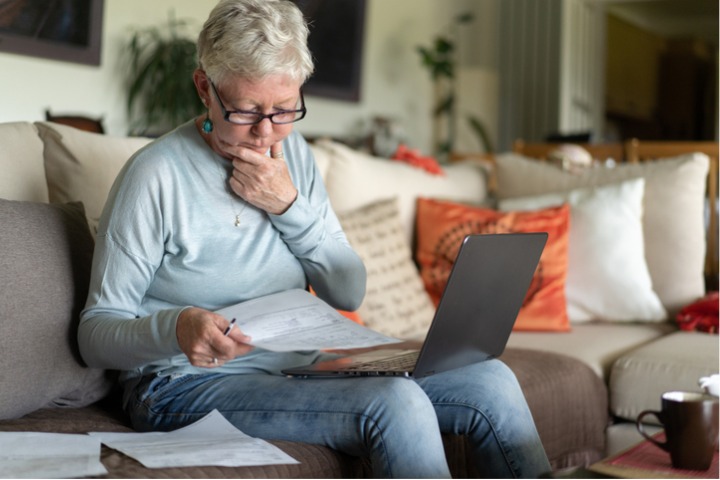 Woman reading over her estate plan in the living room