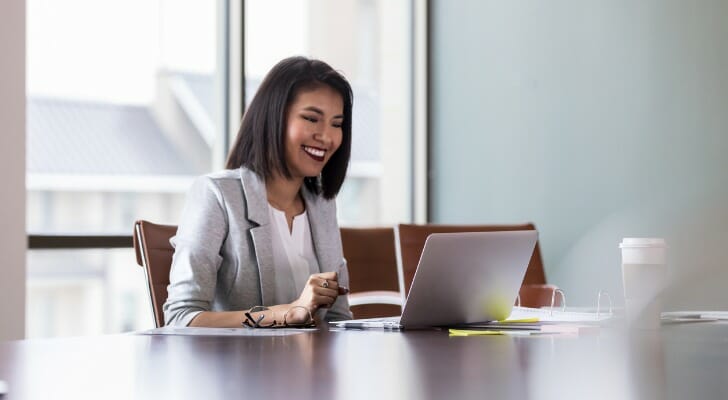 Image shows a financial advisor taking a video call meeting. SmartAsset's study looks at how financial advisors are communicating with clients during COVID-19, and how investor-advisor relationships are changing.