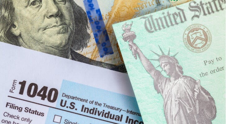 Image shows several U.S. government tax forms and documents. SmartAsset's study looks at how the Trump tax bill affected itemized deductions.