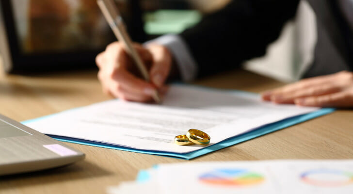 A spouse fills out divorce paperwork in Alabama.