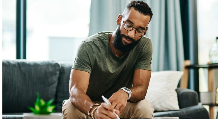 A man reviewing the benefits and drawbacks of rolling over an IRA to a 401(k).