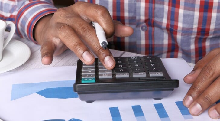 Man calculates benefits of a tax-deferred account.