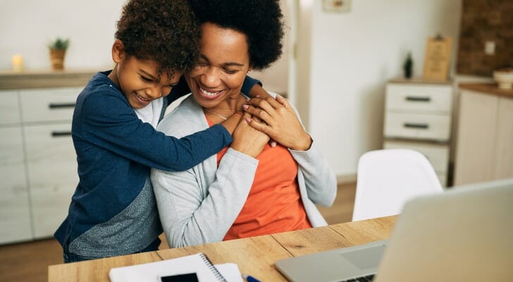 Boy with mother in her home office
