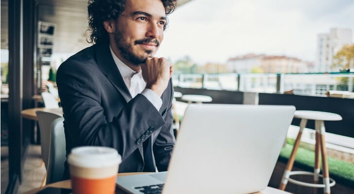 Young man investing with Acorns.