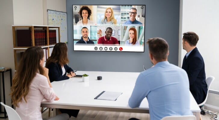 A group of financial advisors discuss a marketing strategy.