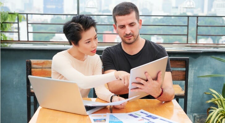Asian female financial advisor with client