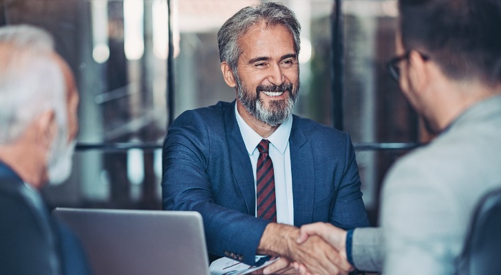 Businessmen shake hands on an LBO deal