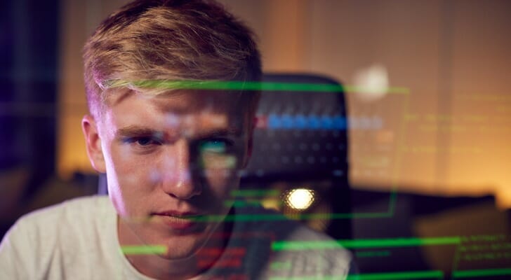 Young man reviews the differences between a hedge fund vs index fund.