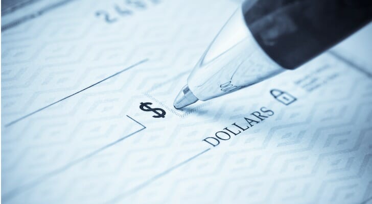 A person filling out a check.