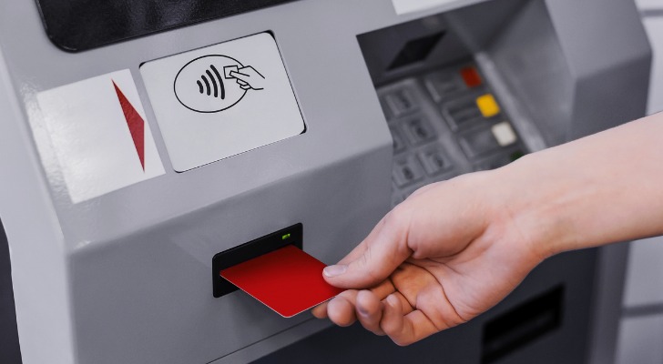 A woman using an ATM.
