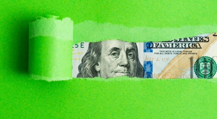 Currency behind green paper.