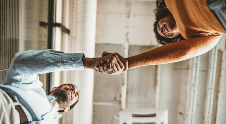 Two people shake hands after establishing a business trust.