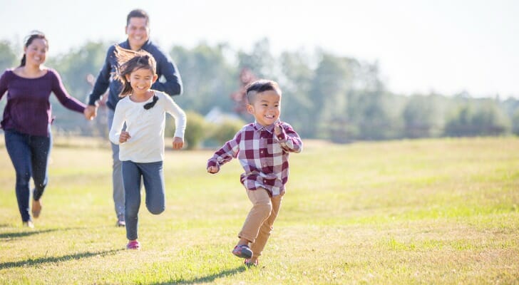 Family running across a field