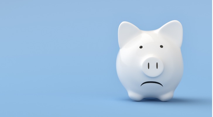 White piggy bank with frowning face