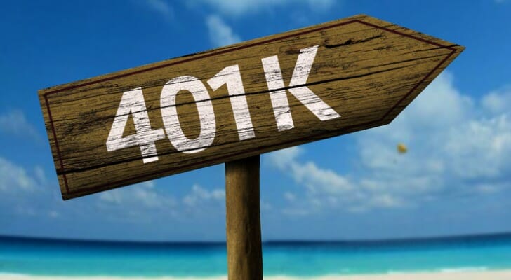 Wooden 401(k) sign on a beach.