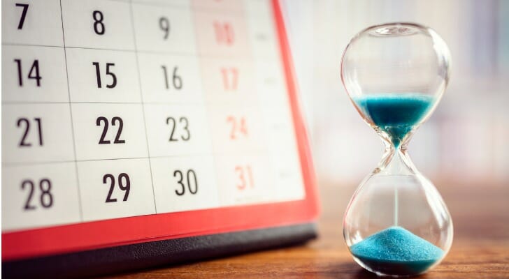 Hour glass next to a monthly calendar