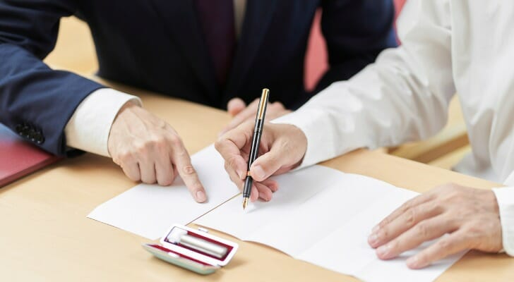 An executor and beneficiary review probate documents together.