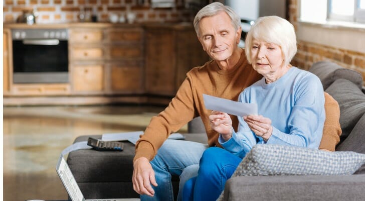A couple looks at Social Security paperwork together. Researchers from the Retirement Research Center at Boston College examined whether the CPI-E is the right index for determining Social Security COLAs.