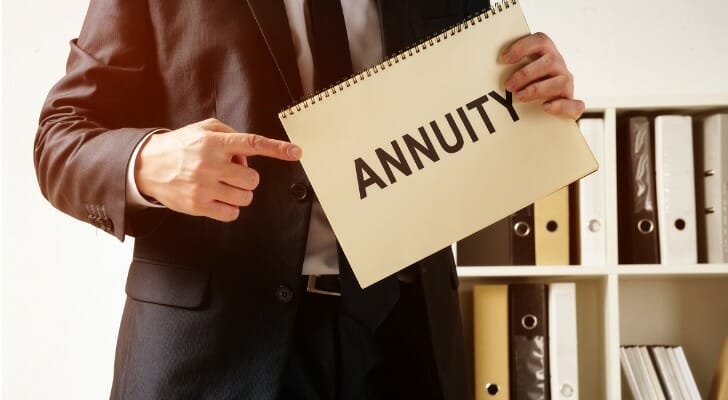 Man holding a sign that says "ANNUITY"