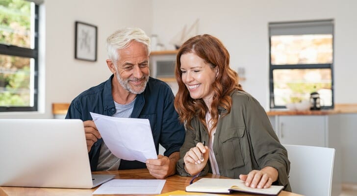 A couple calculates their required minimum distributions (RMDs). The IRS has updated its Uniform Lifetime Table and lowered the size of RMDs.