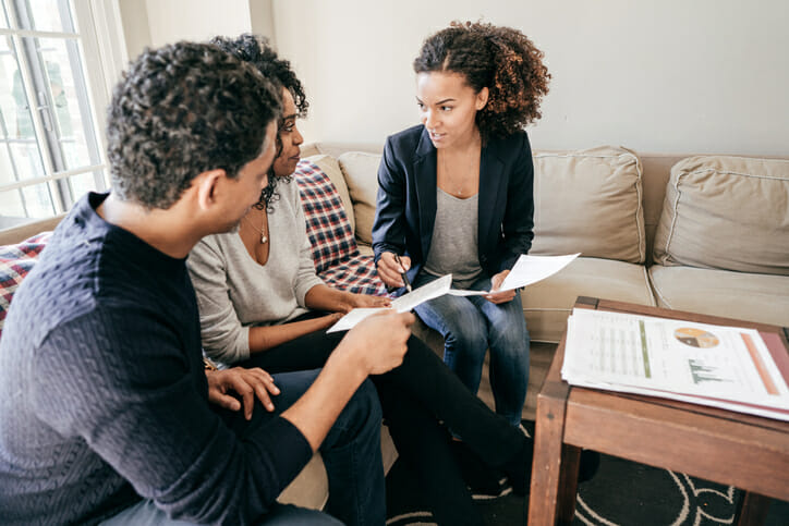A couple meeting with a flat-fee financial advisor.