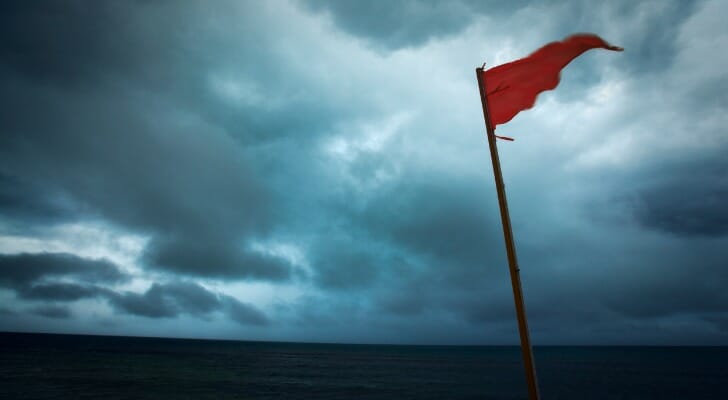 A red flag blows in the wind on a beach. Research from the University of Oregon indicates that financial advisor firms acquired by private equity companies are far more likely to engage in misconduct following their acquisition.