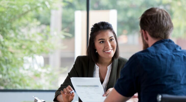 A financial advisor meets with a client. A recent survey found that 38 percent stated that they rely on their financial professional to manage all their investments.
