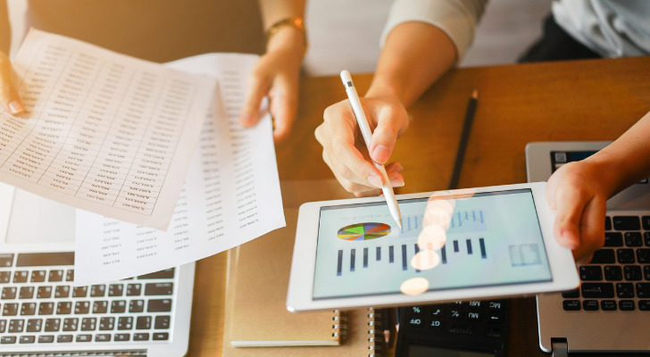 Investors reviewing the dividend yield of investments.