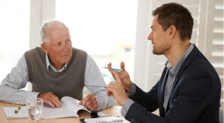 A man discussing how to avoid taxes on an inherited ira with his advisor.