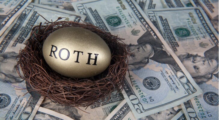 Roth nest egg on top of a pile of cash