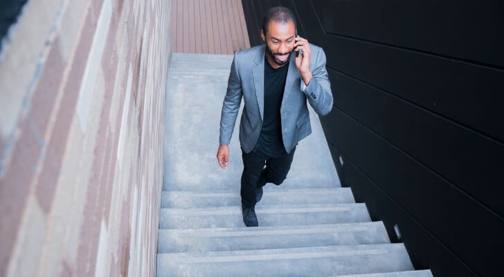 A man in his 30s discussing with his advisor how much he should have in his 401(k).