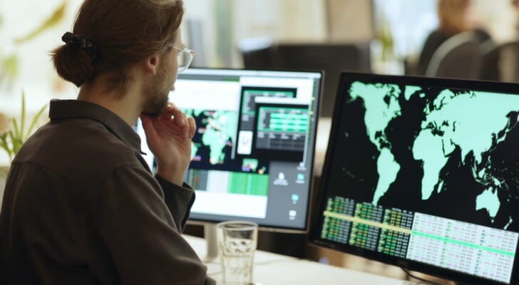 An investor examines international trading data. Schwab projects international large-cap stocks will outperform U.S. counterparts over the next decade.