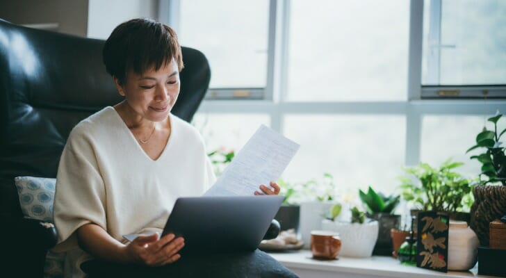 A woman looks over her retirement portfolio on her tablet. JPMorgan has a new tool that helps retirees calculate how much they can safely withdraw from their account each year.