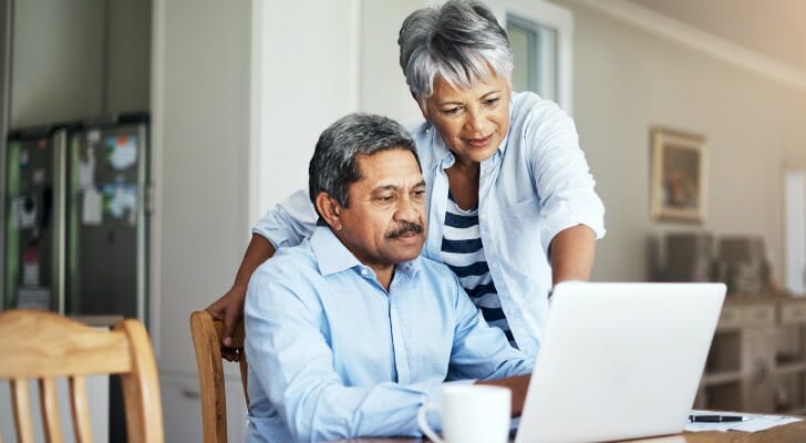 A married couple reviews their retirement accounts on a laptop computer. The U.S. Supreme Court recently declined to hear a lawsuit challenging the CalSavers Retirement Savings Program.