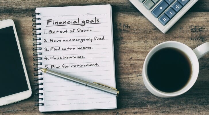 A financial advisor client making a list of financial goals.
