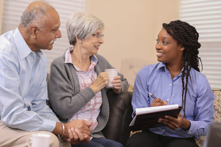 A retired couple talks to their financial advisor regarding whether it is better to take RMD monthly or annually.