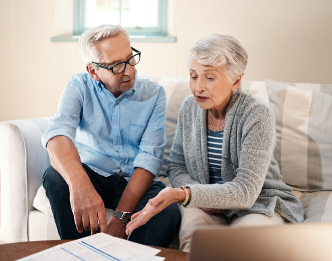 An older couple discusses, "Is it better to take RMD monthly or annually?"