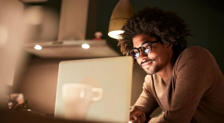 A man reviewing his stock portfolio on a computer.