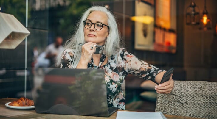 A woman ponders her retirement plan while sitting in a cafe. T. Rowe Price studied alternative withdrawal strategies suited for retirees with a primary focus on meeting their spending needs, as well as those with considerable assets and a desire to leave an estate for their heirs.
