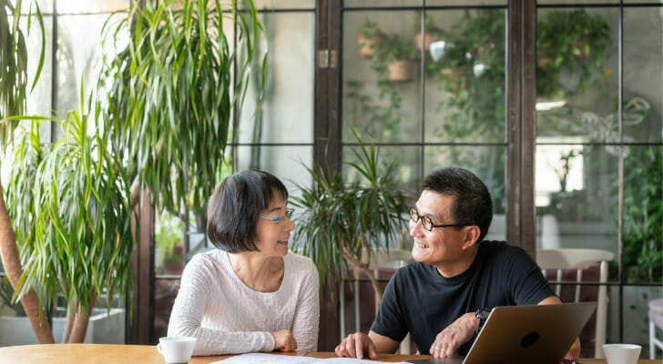 A couple discuss whether to save for retirement or invest in real estate.