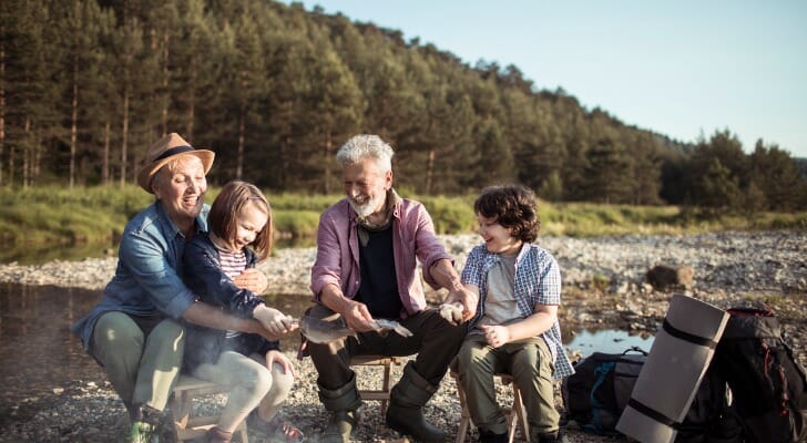 A retired couple take their grandchildren camping.
