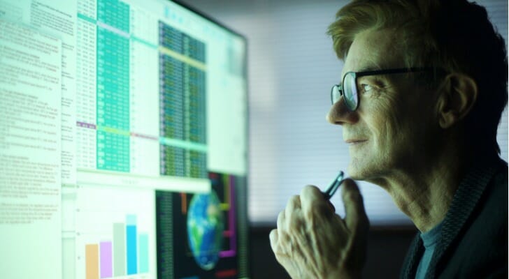 A stock analyst monitors the performance of the market from his computer. New research from Dimensional illustrates the inherent dangers of investing in single stocks as opposed to spreading your assets across a diversified portfolio.
