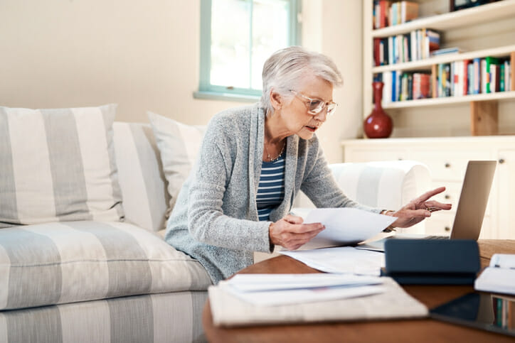 A woman reviewing how to complete a thrift savings plan rollover to IRA.
