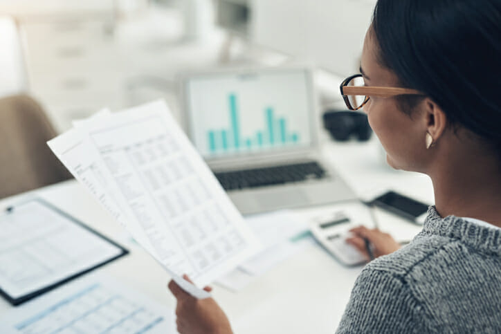 A taxpayer reviewing employment documents before filing her taxes.