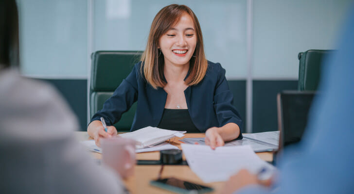 A woman reviews the differences between individual vs joint brokerage accounts.