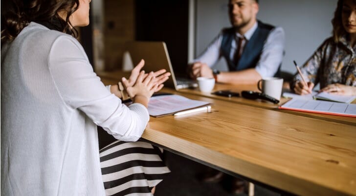 A woman meeting with fee-only financial planners to see if their firm would be a good fit.