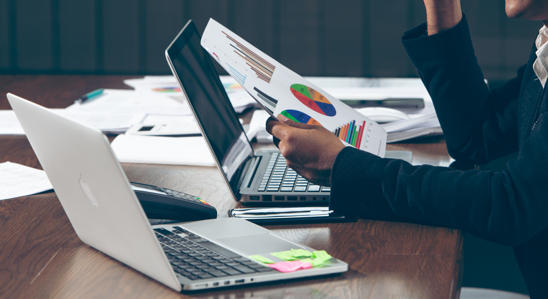 A financial advisor meets with clients to go over a portfolio.
