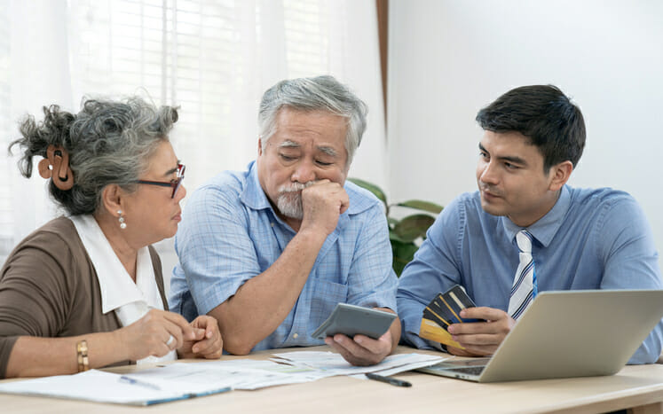 A couple ask their advisor, "Does a living trust file a tax return?"